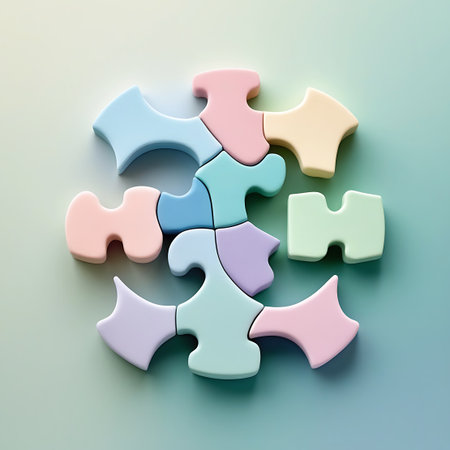 A collection of pastel-colored puzzle pieces are arranged in a circular formation against a soft, gradient background. The pieces are in various shades of blue, pink, yellow, purple, and green, with unique interlocking shapes. The lighting creates a gentle shadow effect, highlighting the smooth texture of the puzzle pieces.の素材