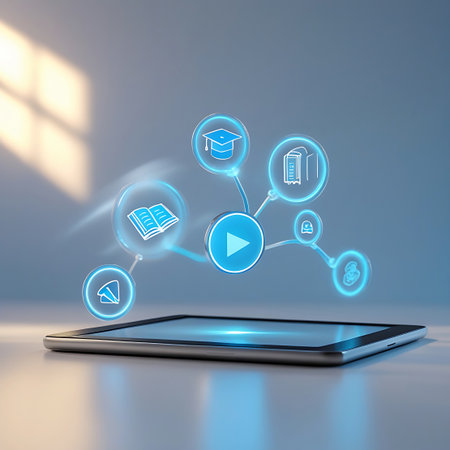 A tablet with a glowing blue screen is positioned in the foreground. Above it, a network of blue digital icons is connected by lines. The central icon is a prominent play button, surrounded by icons of an open book, a book, a person's silhouette, and a document. The background is a soft gray with sunlight casting shadows and highlights.の素材