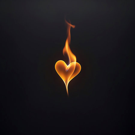 A dynamic flame twists and curls to form the distinct shape of a heart. The flame burns with vibrant shades of orange and yellow, casting a warm glow against a completely black background. The image is stark and dramatic, focusing solely on the fiery heart. It represents intense passion, burning love, or a powerful emotional state.の素材