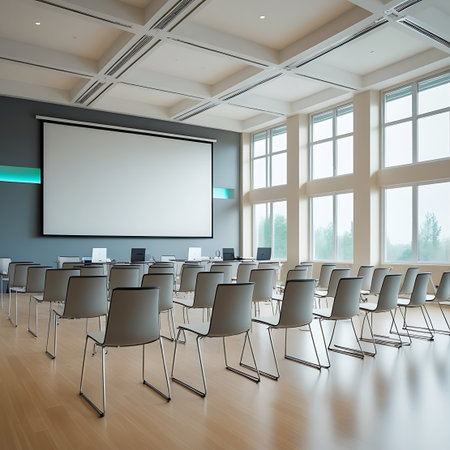 Rows showing modern conference room with projector screen and chairs keywords: conference room, meeting room, auditorium, classroom, presentation, projector screen, chairs, tables, modern, interior, architecture, business, education, corporate, empty, seating, audience, lecture, seminar, training, technology, digital, white screen, windows, natural light, wooden floor, ceiling grid, spacious, professional, setup, venue, gathering, event, learning, discussion, meeting, office, contemporary...の素材