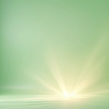 A bright, radiant burst of light emanates from the lower center of the image, appearing as if from a horizon line on a smooth, pale green surface. The light rays fan out upwards and outwards, creating a vibrant and energetic glow. The background is a soft, muted green.の素材