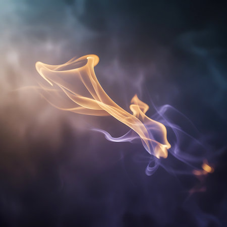 Abstract forms of swirling orange and purple smoke drift and intertwine against a dark, atmospheric background. The translucent wisps of smoke are illuminated by a soft light, creating a glowing effect and highlighting their fluid, organic shapes. The image conveys a sense of gentle movement and ethereal beauty, with a focus on color blending and abstract composition.の素材