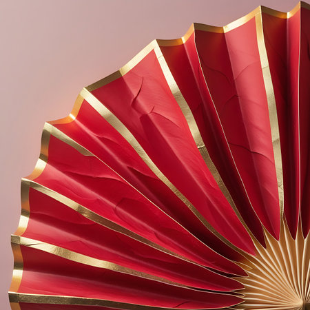 A detailed, close-up shot of a red paper fan, partially opened and fanned out. The fan has a rich red color and is accented with a thin gold trim along the edges of each pleat. The paper exhibits a subtle textured and creased appearance from the folding. The background is a soft, muted pink.の素材
