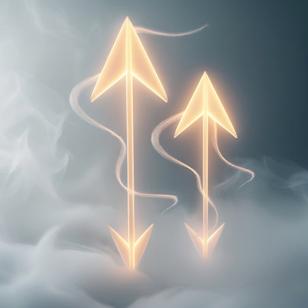 Two illuminated golden arrows are depicted in a smoky, ethereal environment. One arrow points directly upwards, while the other points downwards, creating a visual contrast of direction. Both arrows radiate a warm, soft light, and delicate trails of translucent vapor curl around them, suggesting movement and energy. The background is a soft gradient of blues and grays.の素材