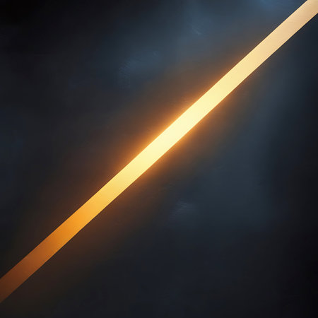 A sharp, diagonal strip of warm golden light is positioned against a dark, subtly textured background. The light is uniform and bright, creating a strong visual line that draws the eye across the frame. The dark background has a slight grain or texture, adding depth without distraction.の素材