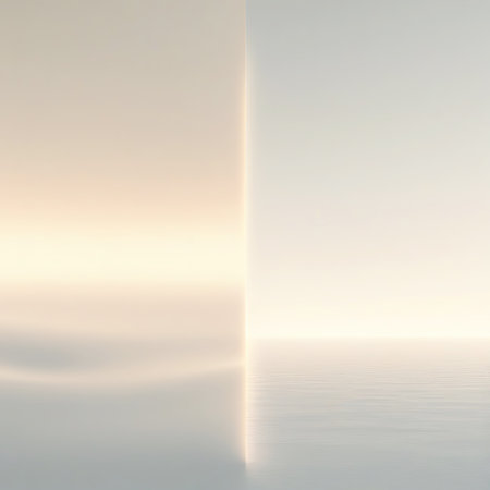 An abstract, ethereal scene with a soft, diffused light creating a sense of a serene landscape. The image is divided vertically. The left side features soft, undulating forms in warm, pale tones, suggesting rolling hills or gentle waves. The right side is a smooth, cool grey. A subtle horizontal line of light divides the lower portion of the image.の素材