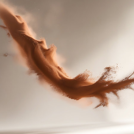 This abstract image depicts a swirling cloud of brown powder in dynamic motion. The fine particles are suspended in the air, creating a sense of energy and dispersion. The soft studio lighting and subtle shadows add depth and texture to the airborne material.の素材