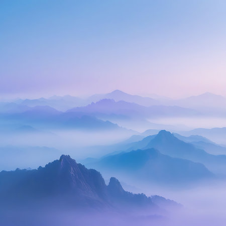 Jagged mountain peaks emerge from thick mist, bathed in soft purple and blue light during sunrise. Clear details and vibrant colors enhance visual appeal.の素材