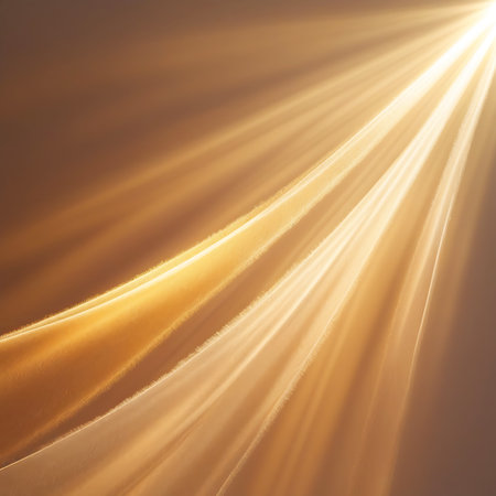 Golden light rays stream diagonally through soft, flowing fabric folds, creating a warm, luminous, and ethereal abstract background with subtle shadows.の素材
