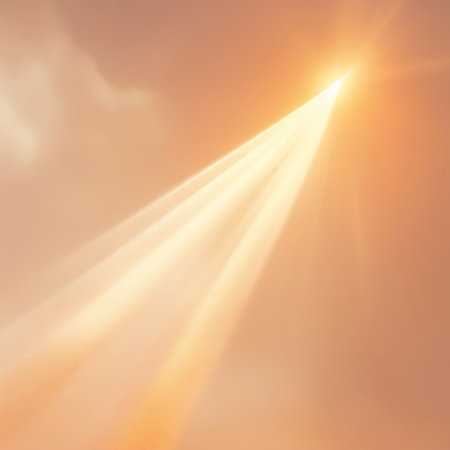 A golden light beam emanates from the upper right corner, shining upwards through a soft orange sky with subtle clouds.の素材