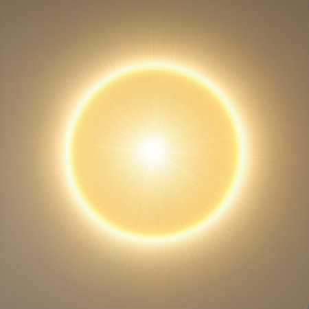 This image captures a vivid and radiant sun in the sky. The sun appears as a large, bright circle with a glowing yellow hue, surrounded by a soft, diffused light. The sky around the sun is a light beige color, adding to the serene and warm atmosphere of the scene.の素材