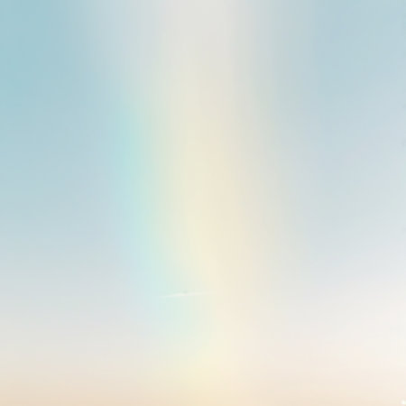 This image features a soft, pastel gradient background with a smooth transition of colors. The gradient starts with a light blue at the top and gradually transitions to a pale yellow at the bottom. The overall effect is calming and serene, creating a peaceful atmosphere.の素材