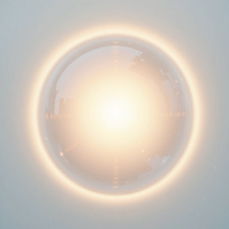 The image depicts a bright circular light against a gray background. The light appears to be emanating from the center, creating a halo effect around its edges. The overall tone of the image is soft and ethereal, with the light being the primary focus.の素材