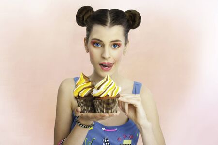 Beauty girl holding big cupcakesの写真素材