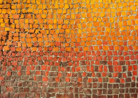 Old mosaic on the wall, colorful little square pebbles in warm toneの写真素材