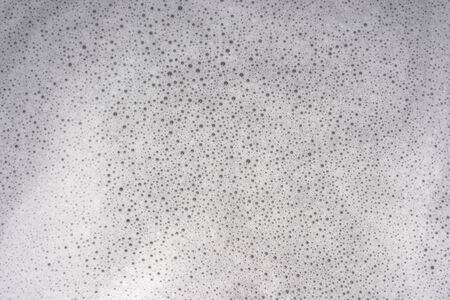 Foam and bubbles on water from washing powder.の写真素材