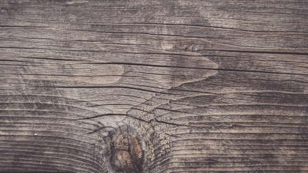 Wooden background. Faded and darkened old wood board due to atmospheric influences.の写真素材