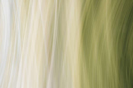 Abstract background of vertical curved stripes in olive green shades. The photo was taken with a long exposure.の写真素材