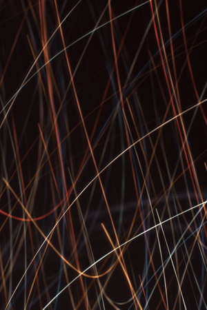 Blurred light from festive garlands. Backdrop. Vertical background with multicolored lines.