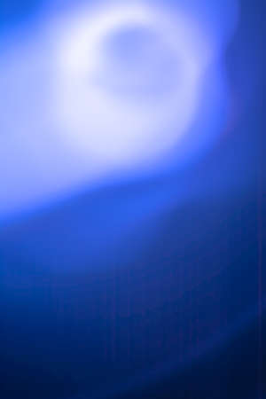 Vertical abstraction in blue tones, the light of the full moon in the fog.の写真素材