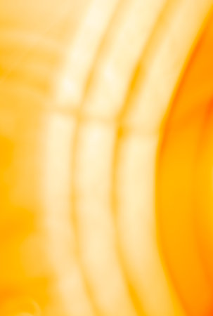 Vertical yellow orange background with glowing arcs. abstraction. backdropの写真素材