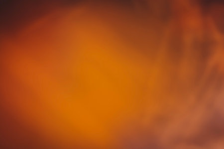 abstract orange background with some smooth lines in it and some spots on itの写真素材