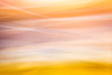 Abstract motion blur effect. Colorful background in yellow orange tones. Blurred wavy background. backdropの写真素材