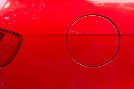Close-up of the round fuel tank cap of a red car. Theme design and technology.の写真素材