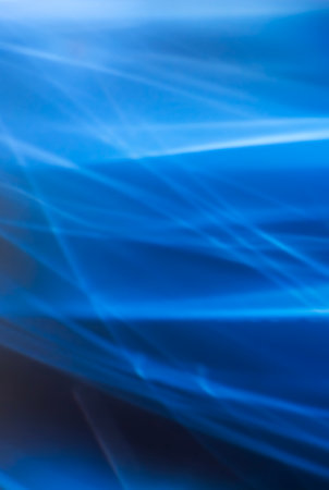 Abstract vertical blue background with smooth lines and blur, light refraction and waves. Backdrop. Design element.の写真素材