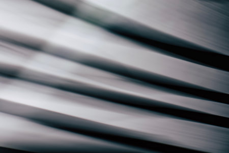Abstract horizontal striped background with smooth lines and highlights in black and gray tones....