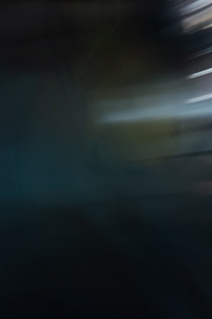 Abstract effect in dark tones, blur in the movement of light from the lights on the old wall at...