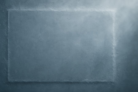 A textured concrete surface features a defined rectangle in the center with soft light shining from above, creating a minimalist backdrop for design needs.の素材