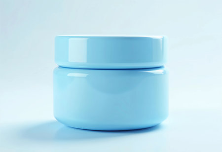 A smooth, light blue container sits serenely against a pale backdrop, showcasing its simple yet elegant design. The soft colors evoke a sense of calm and order in a stylish setting.の素材