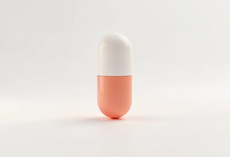 Set against a smooth, light background, a vibrant pink and white pill capsule stands upright, symbolizing innovation in health and wellness with a modern twist on traditional design.の素材
