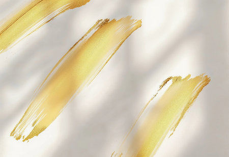 Soft golden brush strokes gracefully adorn a creamy background, creating a luxurious atmosphere. The gentle play of light enhances the texture, inviting a sense of warmth and elegance.の素材