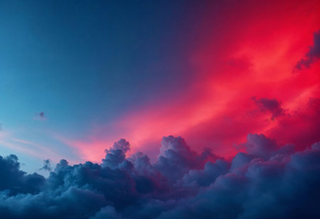 A breathtaking display of colors unfolds as the sun sets, painting the sky in shades of blue and red. Puffy clouds drift through the stunning atmosphere, creating a dreamlike ambiance.の素材