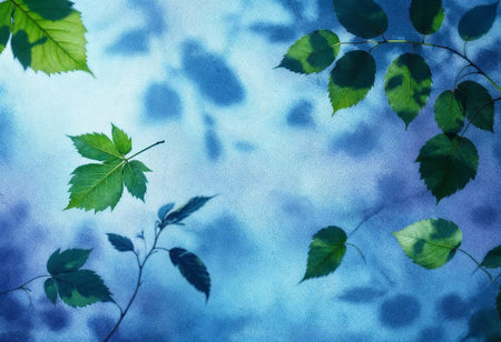 Delicate green leaves gently sway against a serene blue background, capturing the tranquility of twilight. The peaceful atmosphere invites a moment of calm reflection and appreciation of nature.の素材