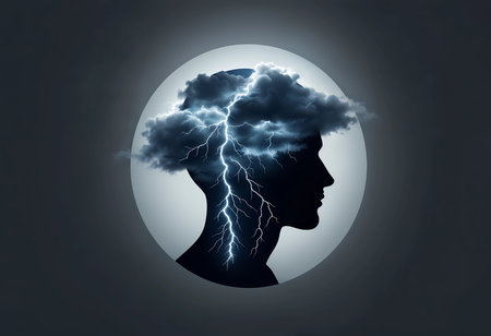 A silhouette of a human head is filled with dark clouds and lightning bolts, symbolizing intense thoughts and emotions.の素材