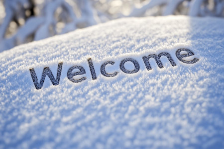 A cheerful welcome is etched in the fresh snow, encapsulating the spirit of winter. Surrounded by nature's icy beauty, the inscription invites visitors to embrace the seasonal charm.の素材