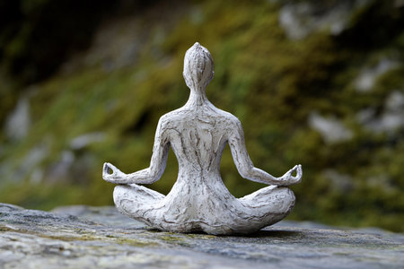 A serene figure meditates in a natural setting, embodying tranquility and harmony. The timeless pose and peaceful surroundings invite mindfulness and reflection, enhancing inner balance.の素材