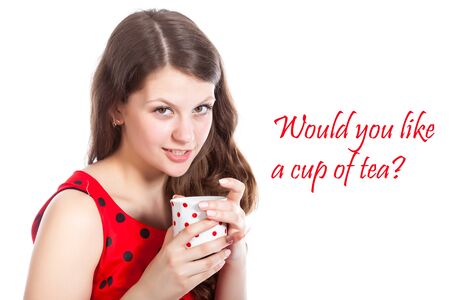Young girl with a cup of tea in her hands  Isolated on white background  Studio shotの写真素材