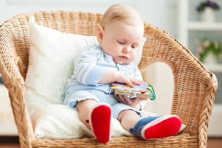 Boy is sitting on armchair  Studio shot