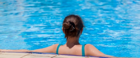 A relaxing woman is in the swimming poolの写真素材