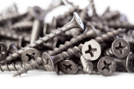 A lot of black drywall screws close-up