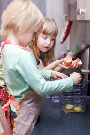 Boy and girl are cooking something in kitchenの写真素材