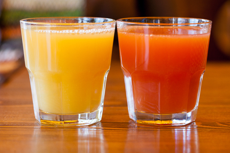 Two glasses with orange and grapefruit juiceの写真素材