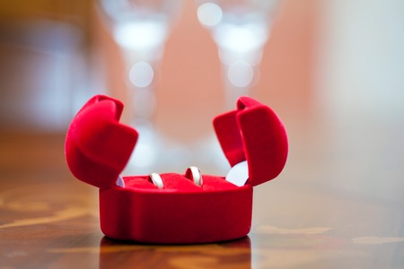 Wedding ringsin red box on the table close-upの写真素材