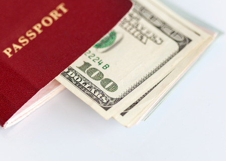 Internatioanl passport and dollar bills. White backgroundの写真素材