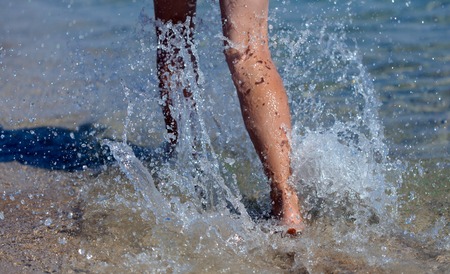 The young woman walking on the beachの写真素材
