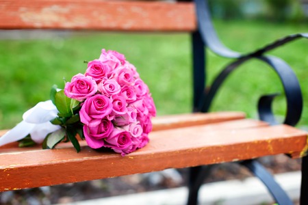Wedding bridal bouquet of roses on the benchの写真素材